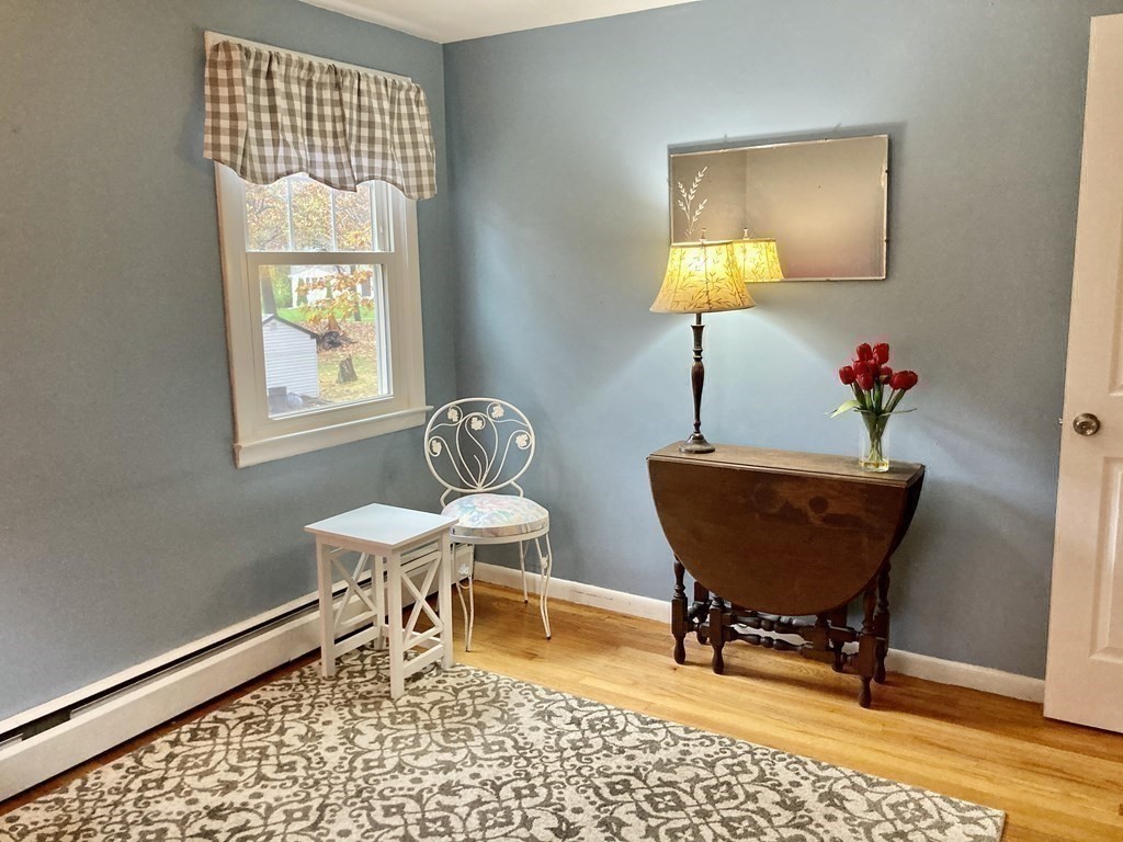 56 Ridge Road South Hadley, MA 01075 - Photo 20 of 37 a living room with a chair and a potted plant