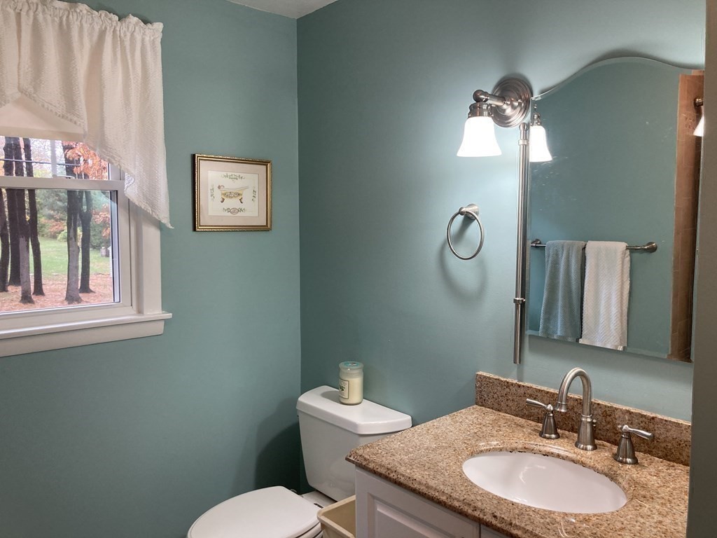 56 Ridge Road South Hadley, MA 01075 - Photo 23 of 37 a bathroom with a granite countertop toilet a sink and a mirror