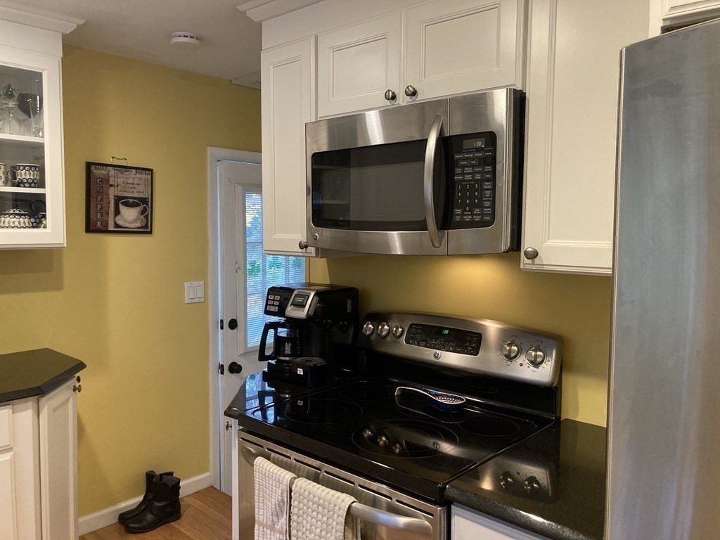 56 Ridge Road South Hadley, MA 01075 - Photo 9 of 37 a kitchen with stainless steel appliances a stove and a microwave