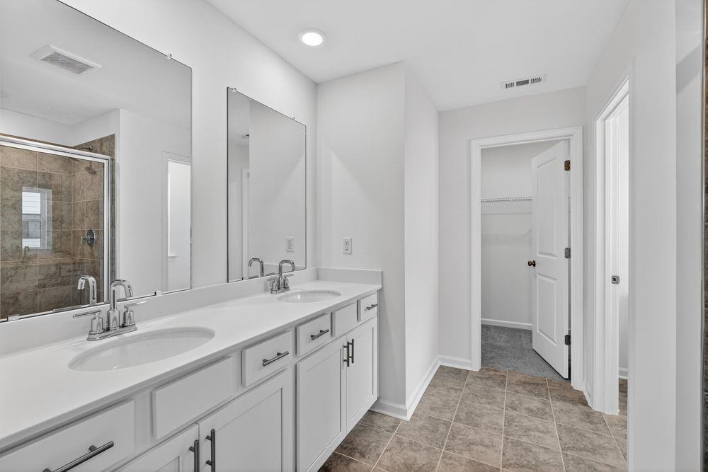2831 Rosehall Way Lawrenceville, GA 30044 - Photo 17 of 53 a spacious bathroom with a double vanity sink mirror and