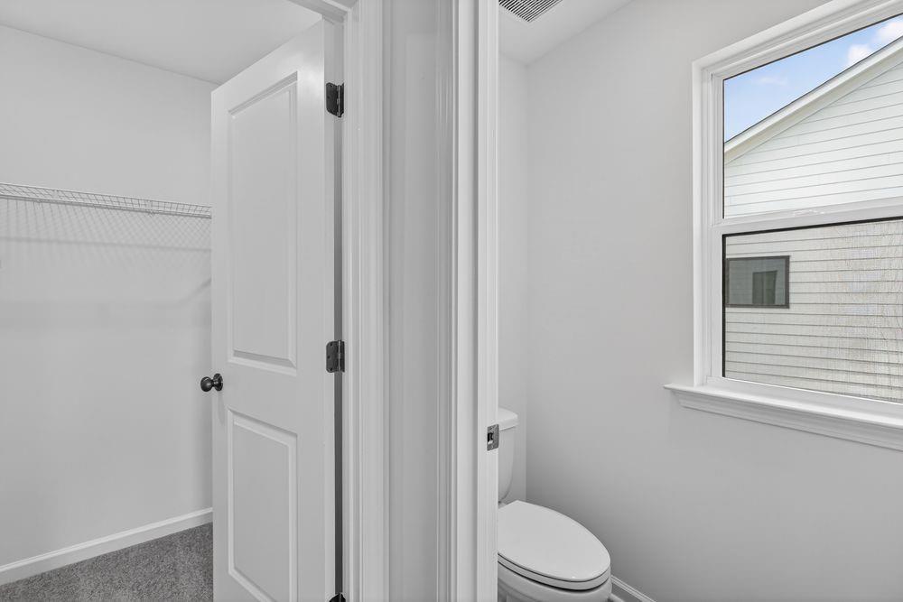 2831 Rosehall Way Lawrenceville, GA 30044 - Photo 18 of 53 a white toilet sitting next to a bathroom sink