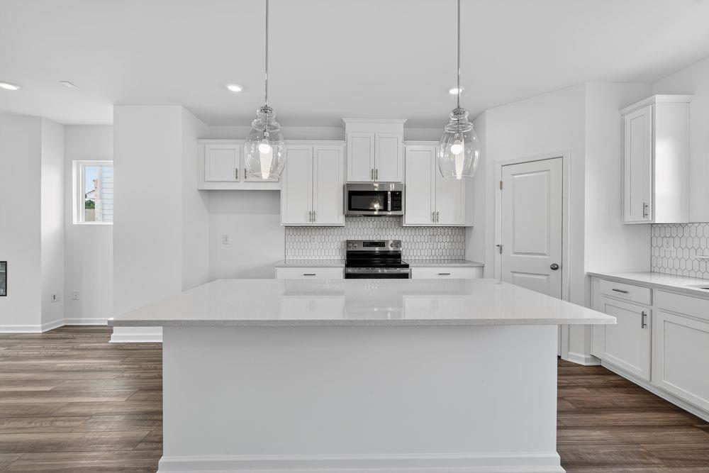 2831 Rosehall Way Lawrenceville, GA 30044 - Photo 2 of 53 a kitchen with kitchen island a sink stainless steel appliances and cabinets