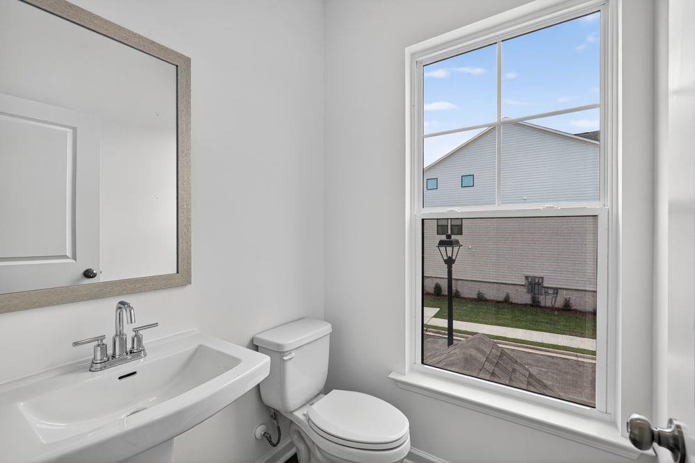 2831 Rosehall Way Lawrenceville, GA 30044 - Photo 33 of 53 a bathroom with a toilet a sink and mirror