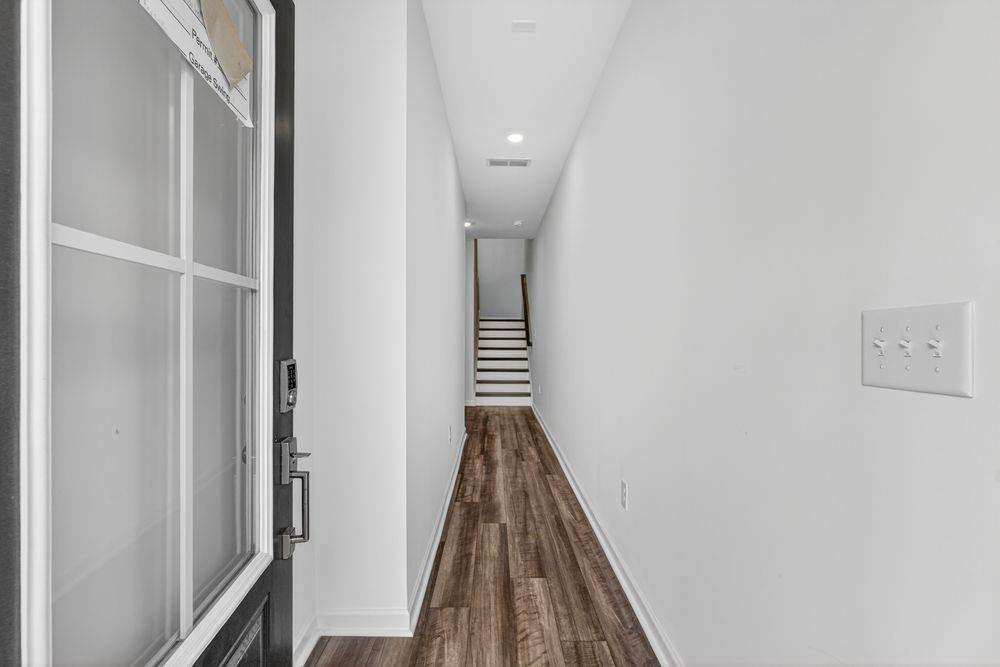 2831 Rosehall Way Lawrenceville, GA 30044 - Photo 36 of 53 a view of a hallway with wooden floor and staircase