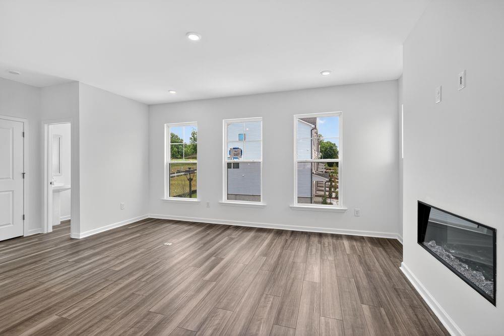 2831 Rosehall Way Lawrenceville, GA 30044 - Photo 9 of 53 an empty room with wooden floor and windows