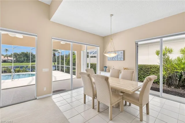 a view of a dining room with furniture large windows and wooden floor