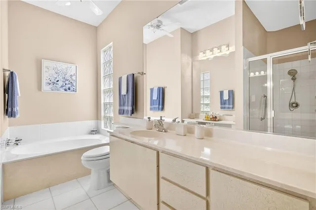 a bathroom with a double vanity sink toilet and shower