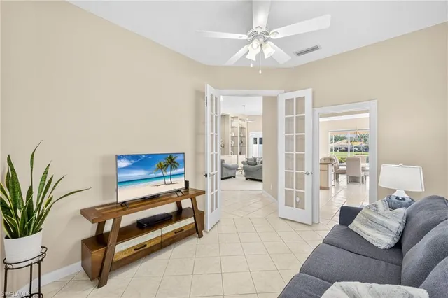 a living room with furniture and a potted plant