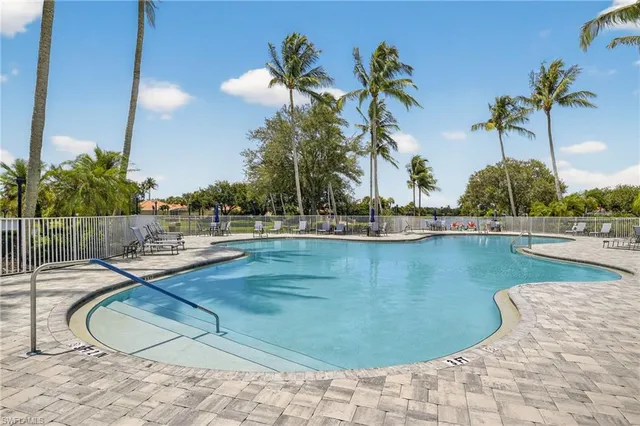 a view of a swimming pool with a chair and tables