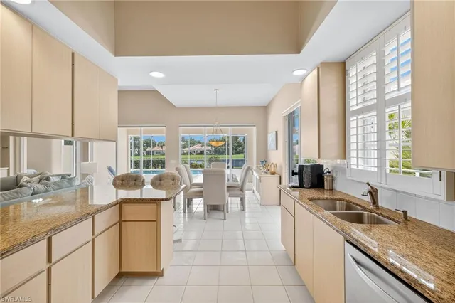 a large kitchen with kitchen island a large window in it