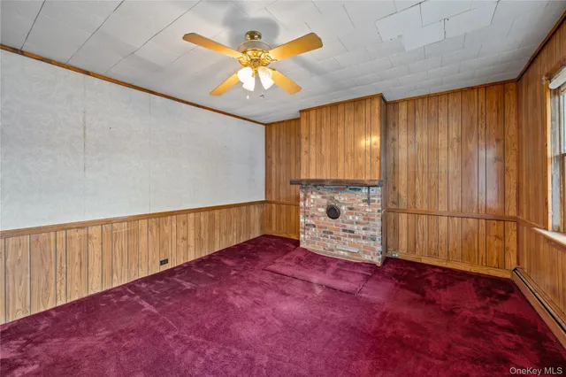 wooden floor in an empty room with a chandelier