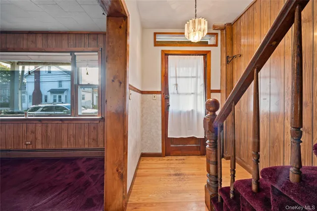 a view of an entryway with wooden floor and door