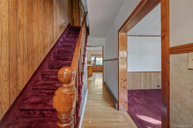 a view of entryway and hall with wooden floor