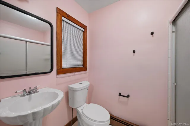 a bathroom with a sink toilet and mirror
