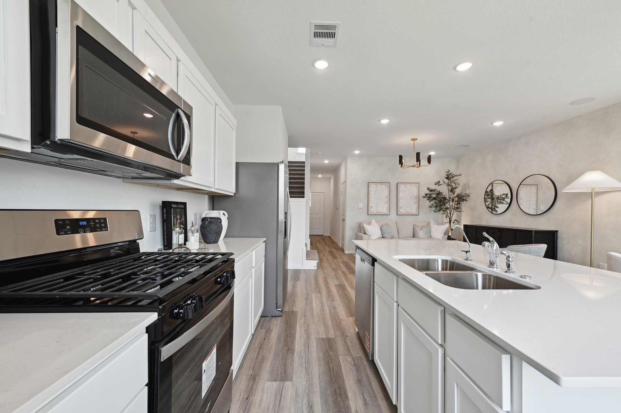 16911 Vinters Way Houston, TX 77090 - Photo 12 of 26 a kitchen with stainless steel appliances granite countertop a sink stove and microwave