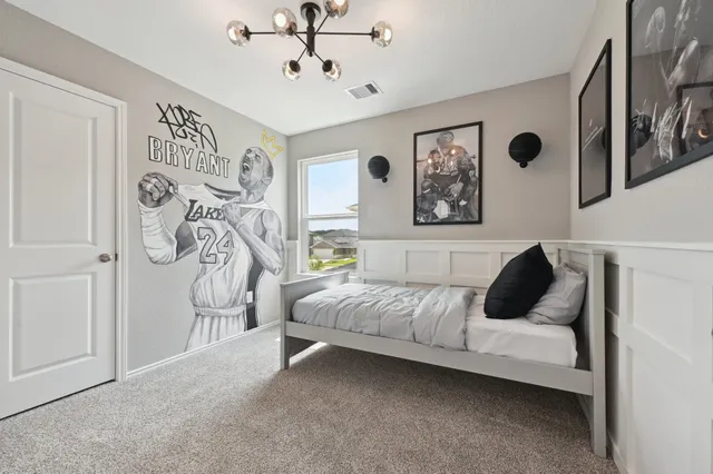 a bedroom with a large bed and a window