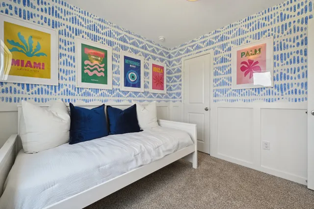 a bedroom with a bed and wall painting