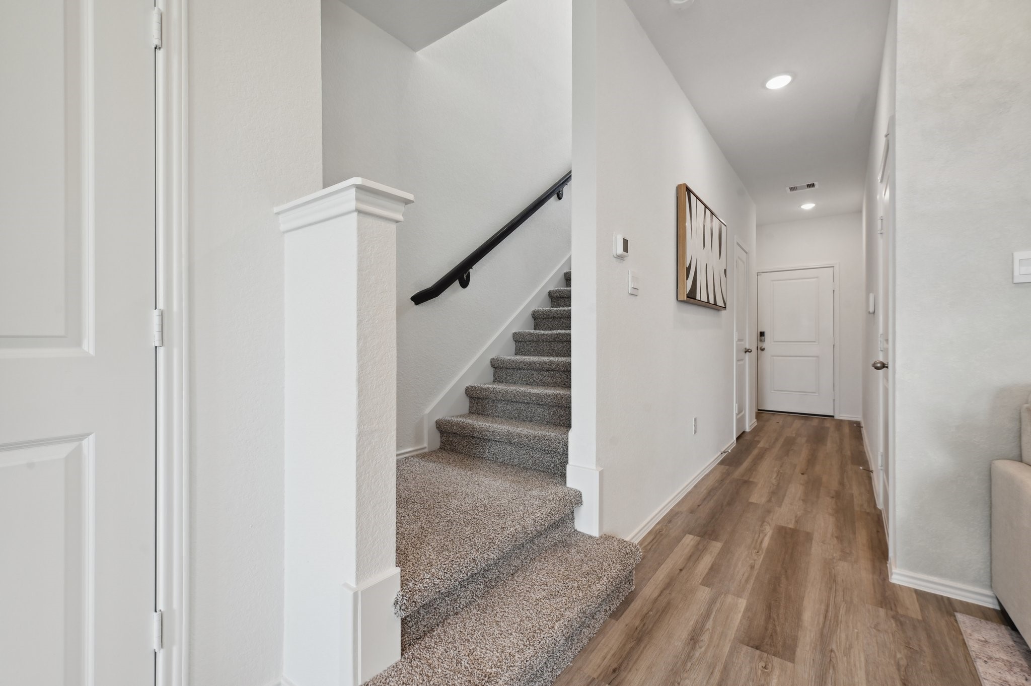 16911 Vinters Way Houston, TX 77090 - Photo 5 of 26 a view of a hallway with wooden floor and entryway