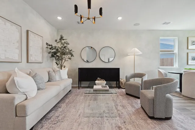 a living room with furniture a fireplace and a large window