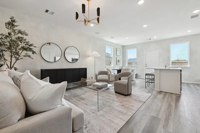 a living room with furniture a fireplace and wooden floor