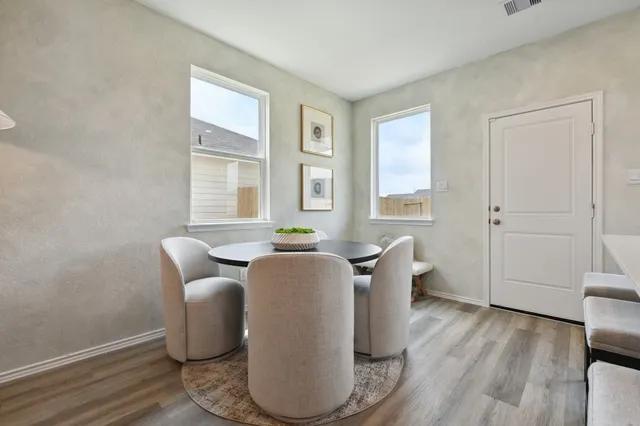 a view of a dining room with furniture window and wooden floor