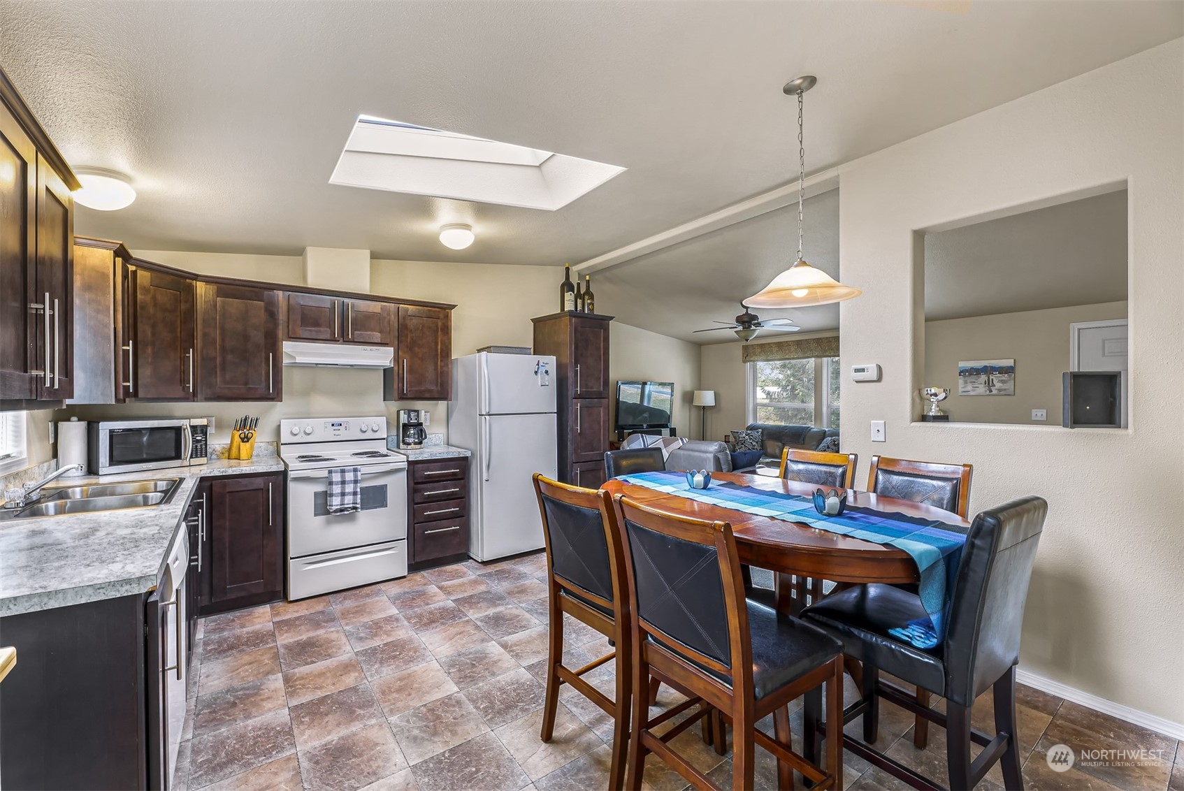 4524 Decatur Drive Ferndale, WA 98248 - Photo 14 of 30 a kitchen with refrigerator cabinets dining table and chairs