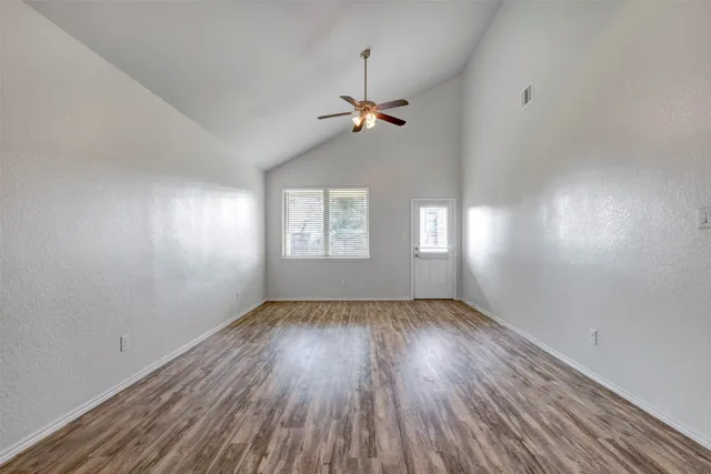 wooden floor in an empty room with a window