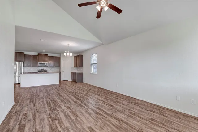 a view of kitchen with refrigerator and window