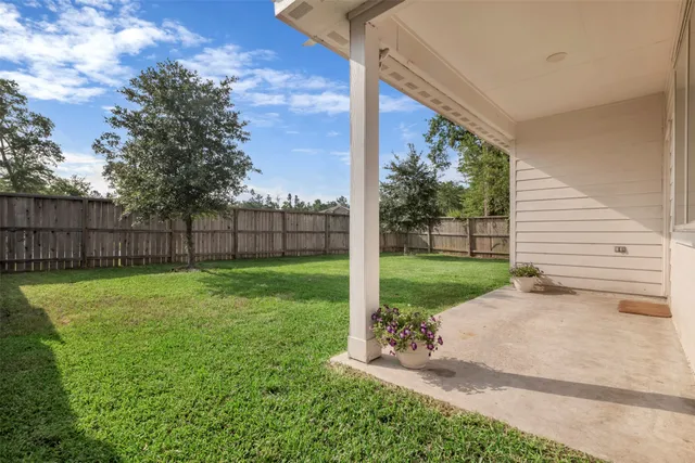 a large kitchen with stainless steel appliances granite countertop a stove top oven a refrigerator a sink and dishwasher with wooden floor