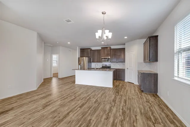 a view of a kitchen with a sink and microwave