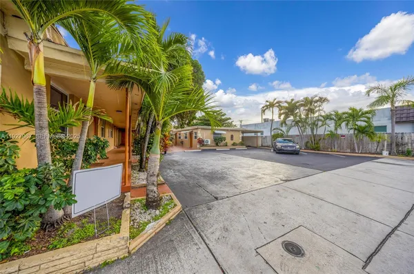 a view of a street with palm trees