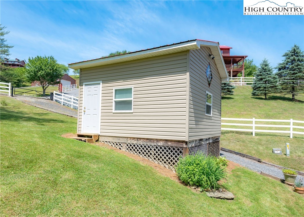 2280 Garvey Bridge Road Crumpler, NC 28617 - Photo 14 of 45 a view of a house with a backyard