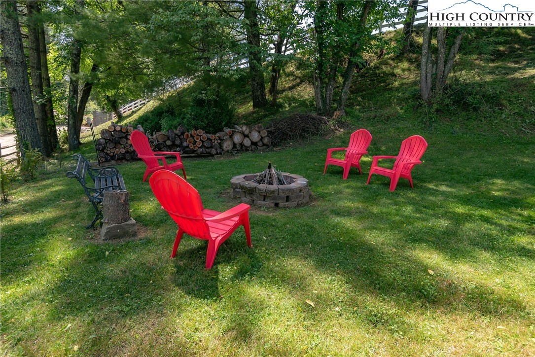 2280 Garvey Bridge Road Crumpler, NC 28617 - Photo 15 of 45 a view of a backyard with table and chairs and a small yard