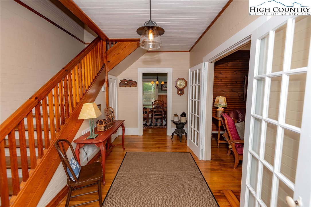 2280 Garvey Bridge Road Crumpler, NC 28617 - Photo 17 of 45 a hallway with wooden floor stairs and furniture