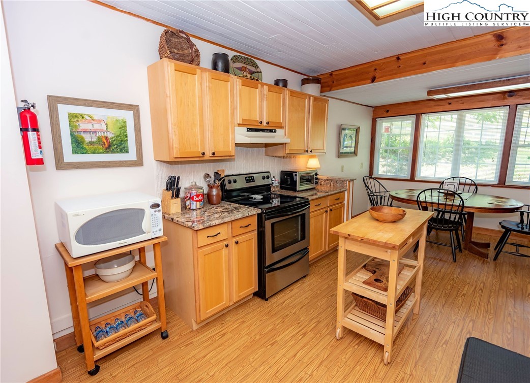 2280 Garvey Bridge Road Crumpler, NC 28617 - Photo 27 of 45 a kitchen with stainless steel appliances granite countertop a stove a sink and a refrigerator