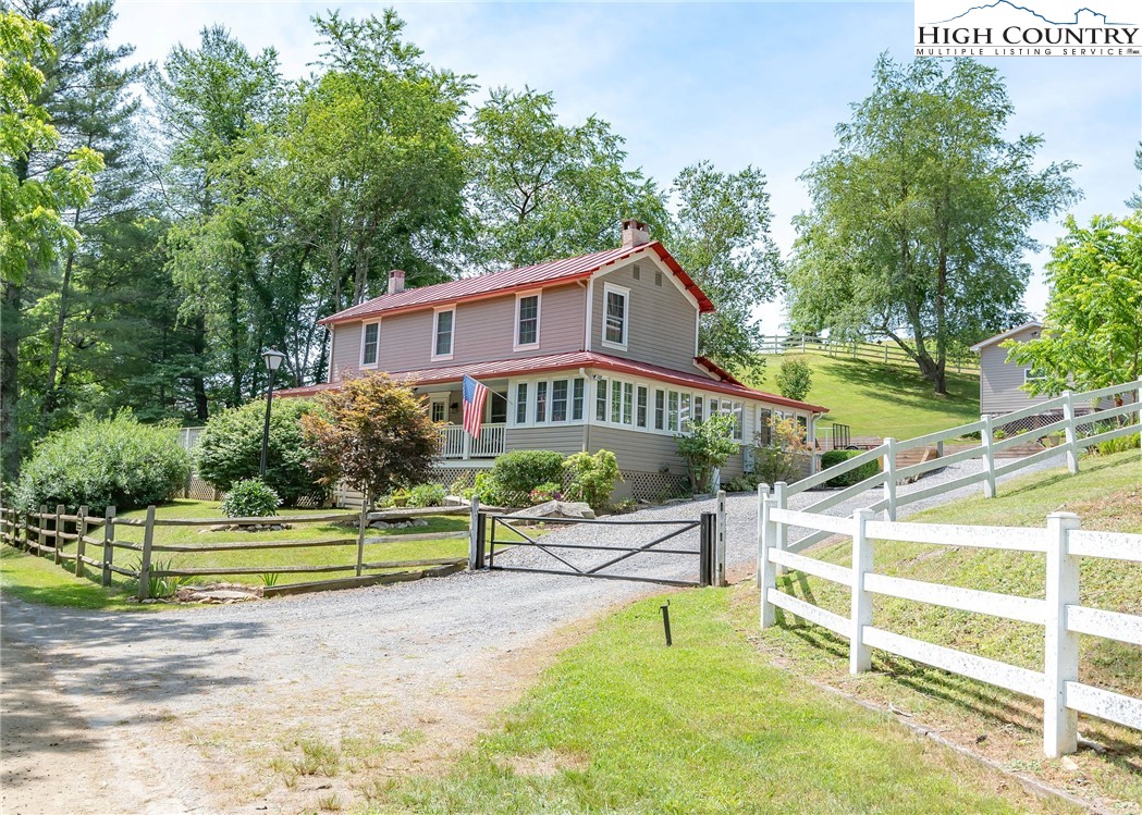 2280 Garvey Bridge Road Crumpler, NC 28617 - Photo 3 of 45 a view of a swimming pool with a house in the background