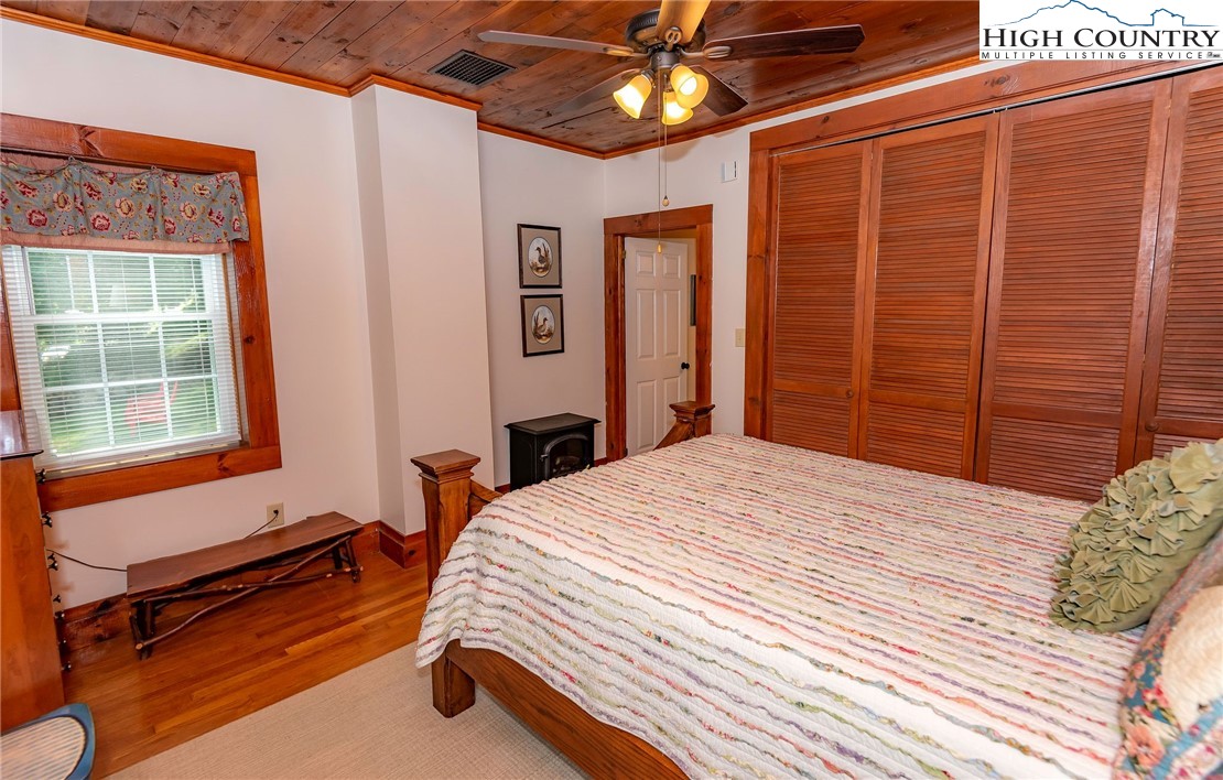 2280 Garvey Bridge Road Crumpler, NC 28617 - Photo 33 of 45 a bedroom with a bed dresser and a window