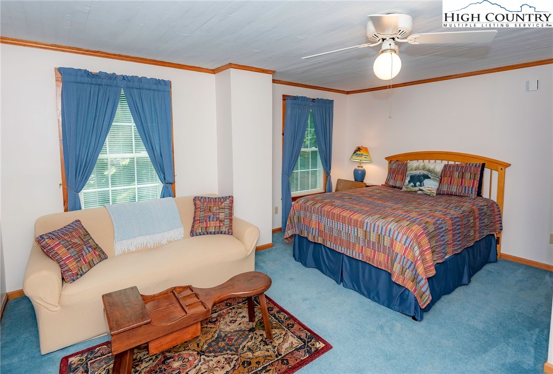 2280 Garvey Bridge Road Crumpler, NC 28617 - Photo 38 of 45 a bedroom with a bed window and couch