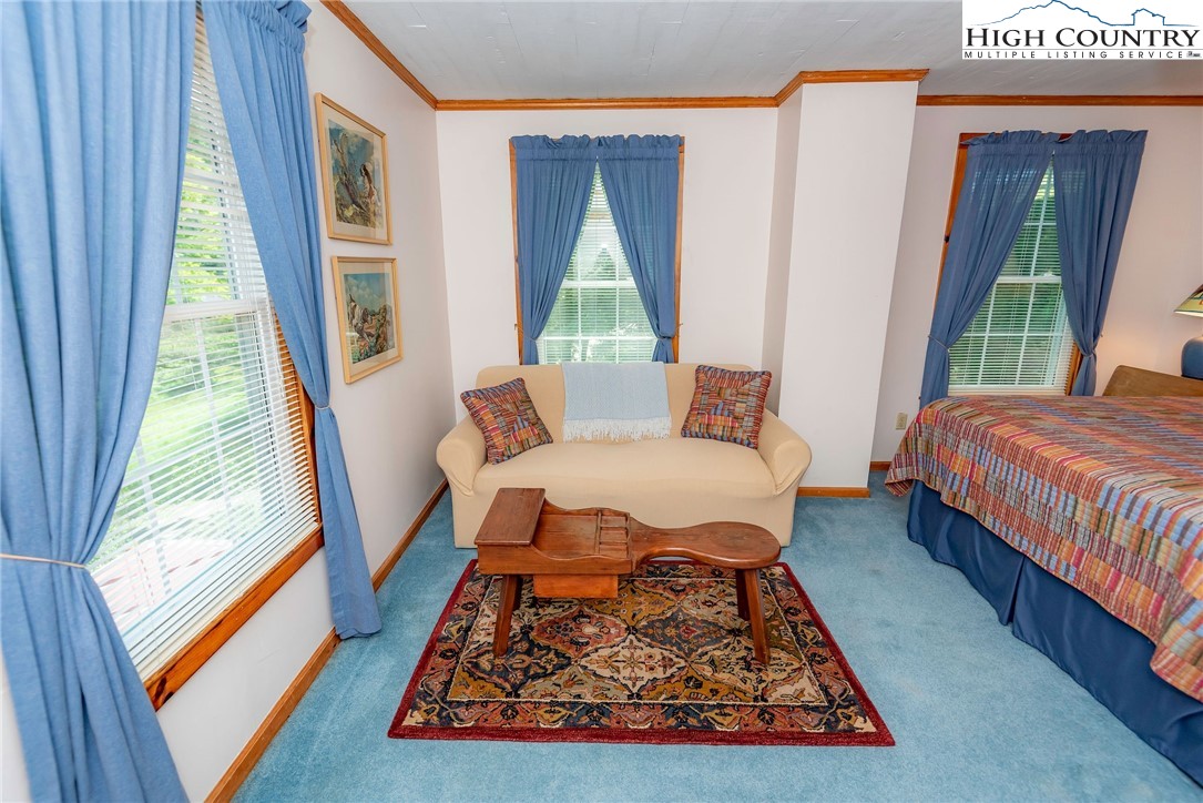 2280 Garvey Bridge Road Crumpler, NC 28617 - Photo 39 of 45 a bed sitting in a bedroom next to a window