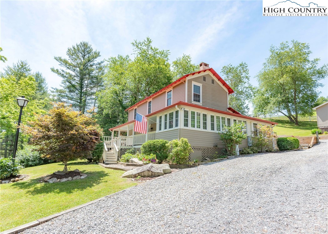 2280 Garvey Bridge Road Crumpler, NC 28617 - Photo 4 of 45 a front view of a house with a yard and a porch