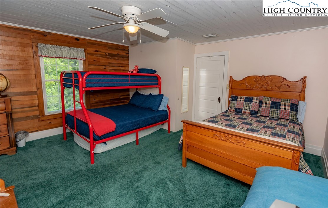 2280 Garvey Bridge Road Crumpler, NC 28617 - Photo 41 of 45 a living room with a bed and a chandelier