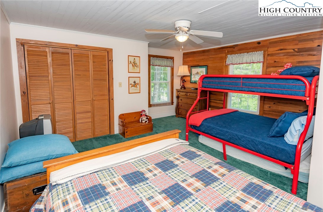 2280 Garvey Bridge Road Crumpler, NC 28617 - Photo 42 of 45 a bedroom with a bed and wooden floor