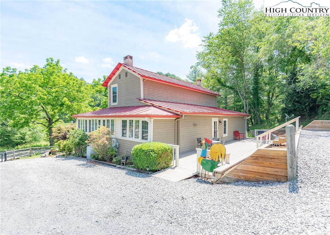 2280 Garvey Bridge Road Crumpler, NC 28617 - Photo 9 of 45 a view of a house with backyard and a tree