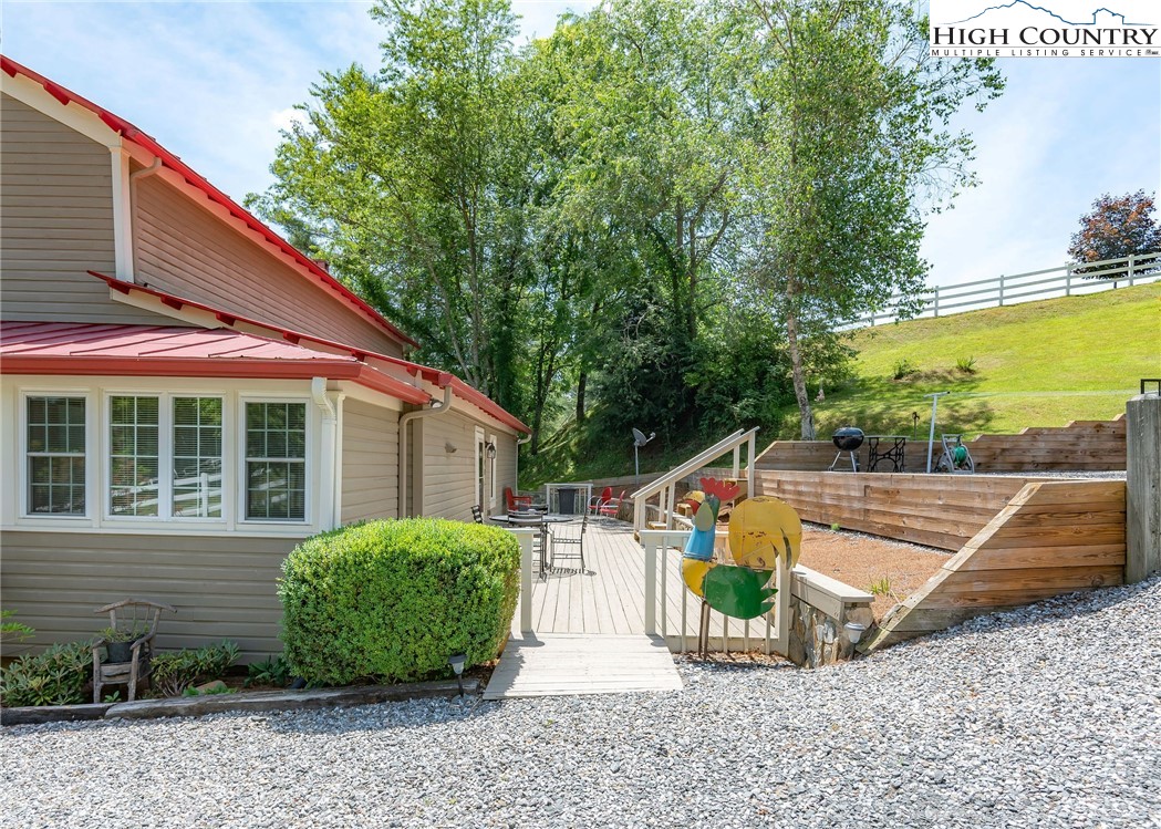 2280 Garvey Bridge Road Crumpler, NC 28617 - Photo 10 of 45 a view of a backyard with plants and a patio