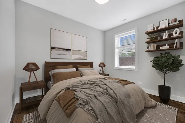 a bedroom with a bed a chandelier and a window