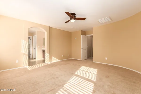 a view of a room with a ceiling fan