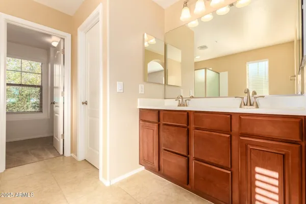 a bathroom with a double vanity sink and a mirror