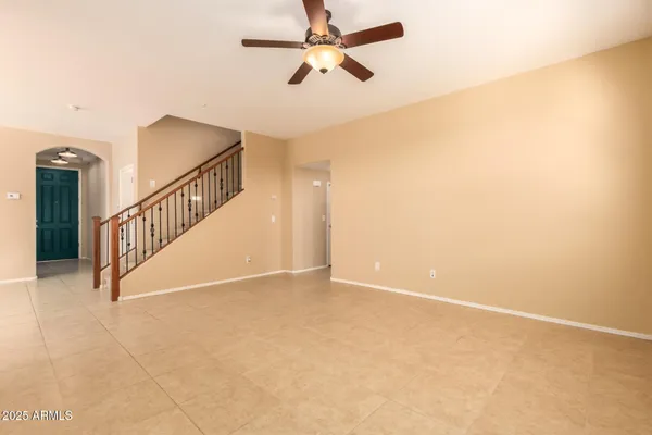 a view of an empty room with a ceiling fan
