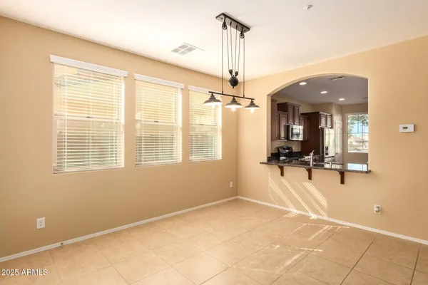 a view of a livingroom with a furniture wooden floor and a chandelier