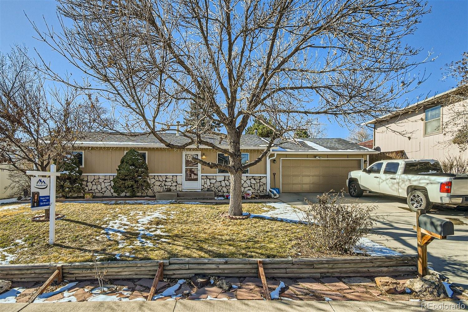 8207 High Street Denver, CO 80229 - Photo 1 of 11 a front view of a house with garden yard